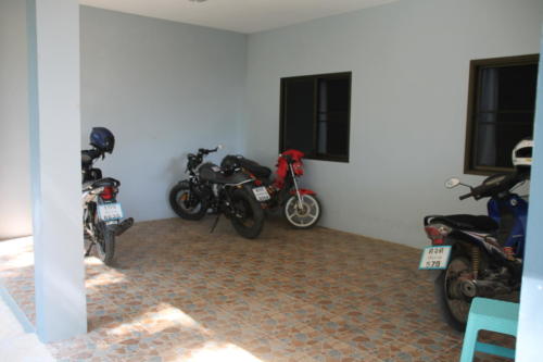 Motorcycle parking area at boy’s house.